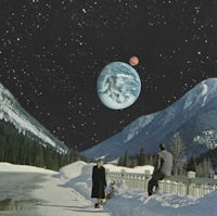 two people standing on a snowy road with a planet in the background